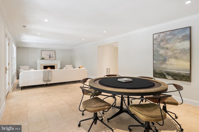 tiled dining space featuring crown molding