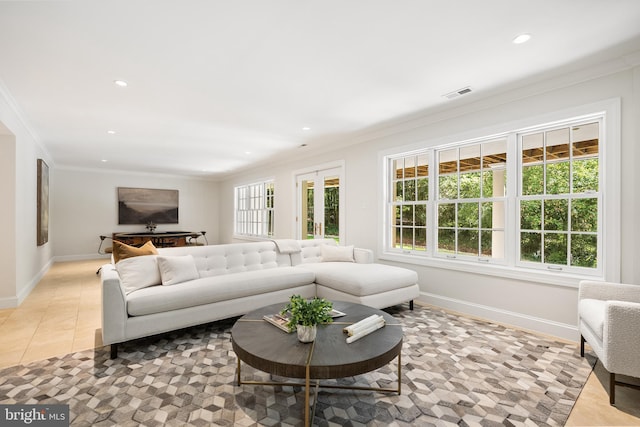 tiled living room featuring a wealth of natural light and ornamental molding