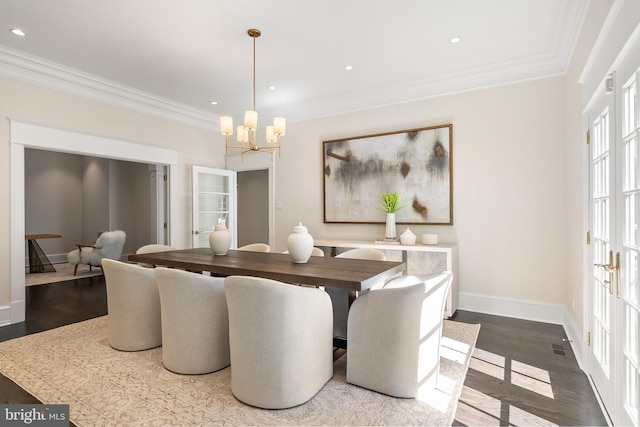 dining space featuring crown molding, hardwood / wood-style floors, french doors, and an inviting chandelier