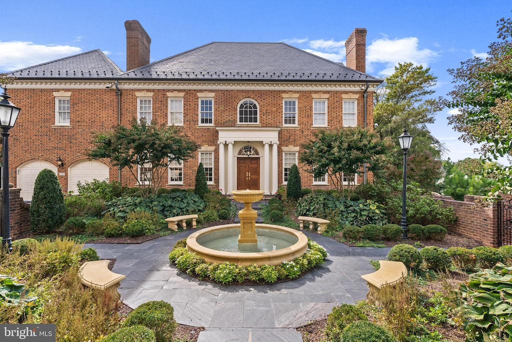 colonial inspired home featuring a garage