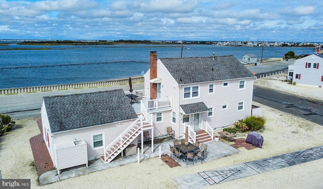 birds eye view of property with a water view