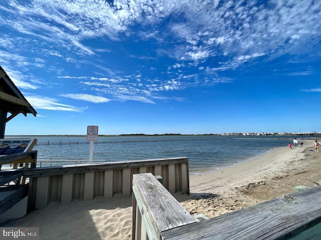 dock area featuring a view of the beach and a water view