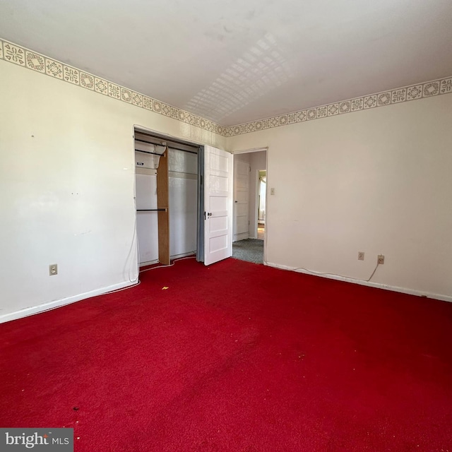 unfurnished bedroom with carpet floors and a closet