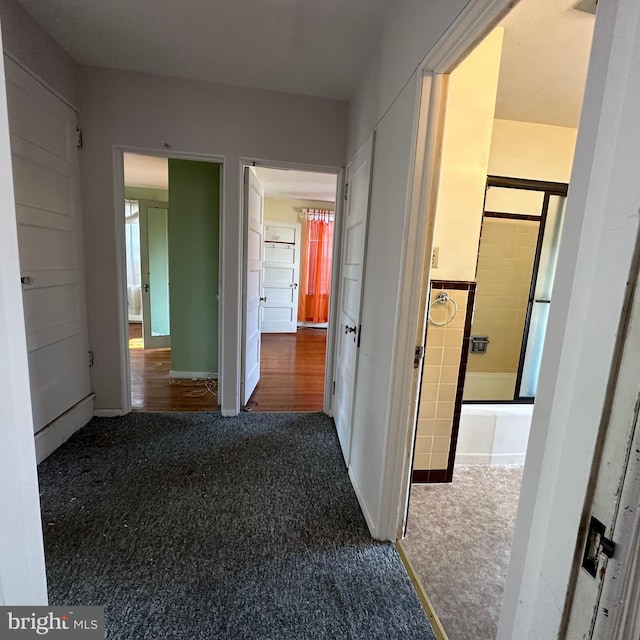 hallway with dark carpet