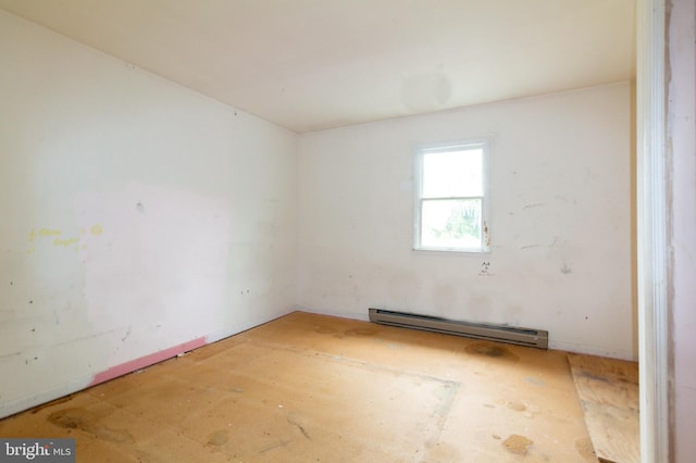 empty room featuring a baseboard heating unit