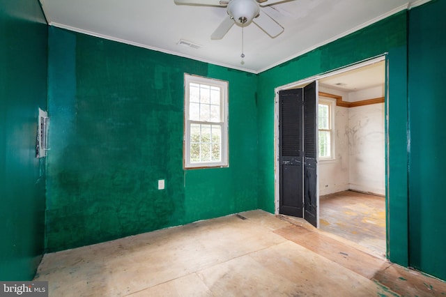 unfurnished bedroom with ceiling fan, a closet, and crown molding