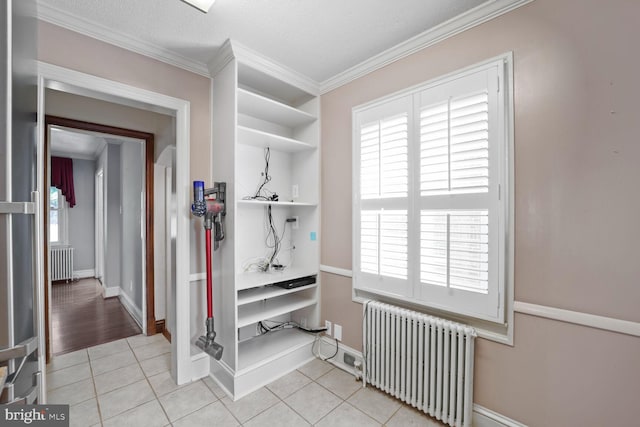 interior space with light tile patterned floors, a wealth of natural light, and radiator