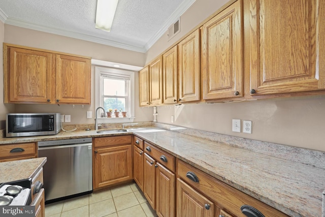 kitchen featuring light stone counters, ornamental molding, sink, a textured ceiling, and appliances with stainless steel finishes