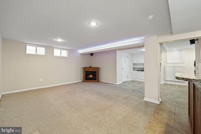 basement featuring light colored carpet