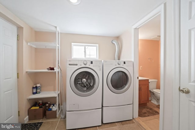 washroom with independent washer and dryer and light tile patterned floors