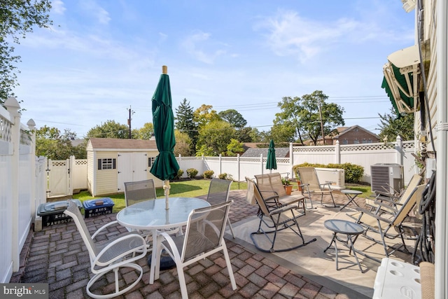 view of patio featuring a storage shed and central AC