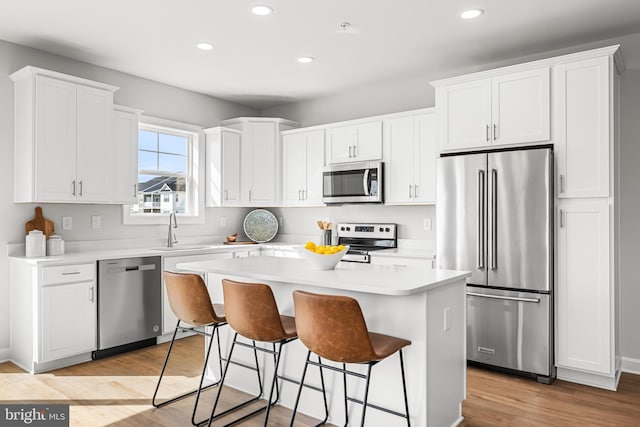 276 Ridge View Ln Unit 46, Hanover, PA 17331 - kitchen featuring appliances with stainless steel finishes, a sink, recessed lighting, white cabinets, and a kitchen breakfast bar
