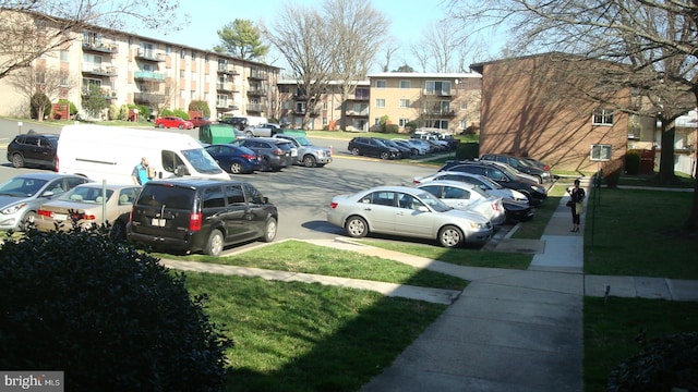 view of vehicle parking featuring a lawn