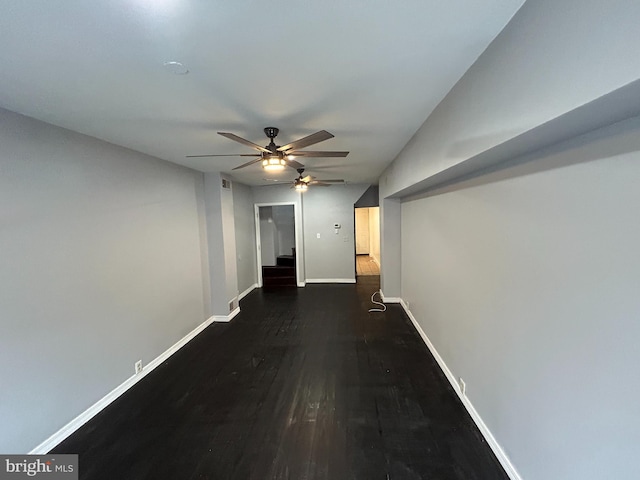 corridor with dark hardwood / wood-style flooring