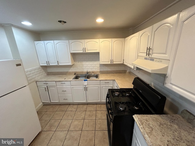 kitchen with black gas range, tasteful backsplash, white cabinetry, and sink