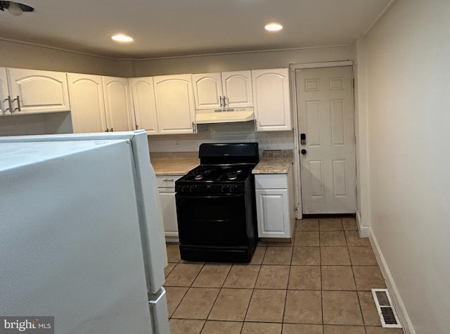 kitchen with white cabinets, black gas range oven, and white fridge