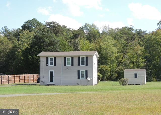 view of outbuilding with a yard