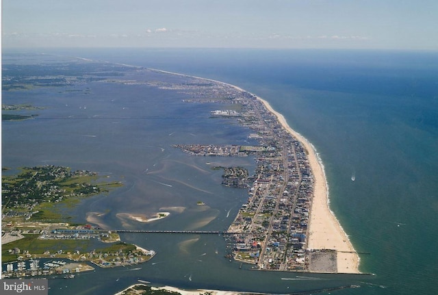 birds eye view of property featuring a beach view and a water view