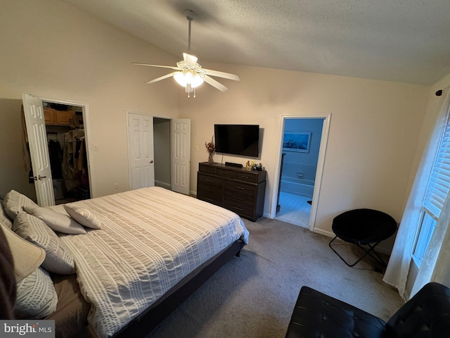 bedroom with a spacious closet, ceiling fan, connected bathroom, and lofted ceiling