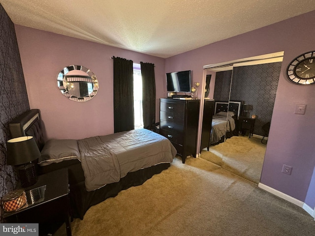 bedroom featuring light colored carpet and a textured ceiling