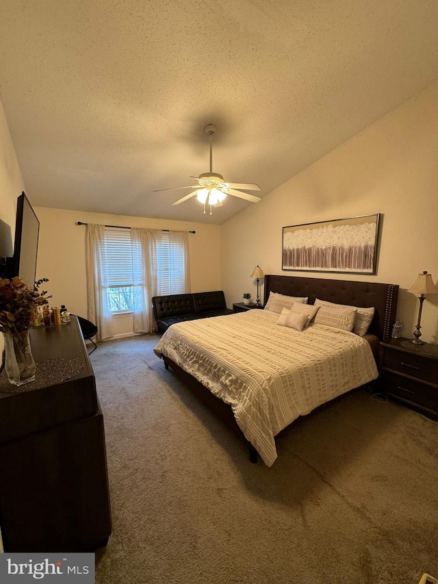 carpeted bedroom with ceiling fan, a textured ceiling, and vaulted ceiling