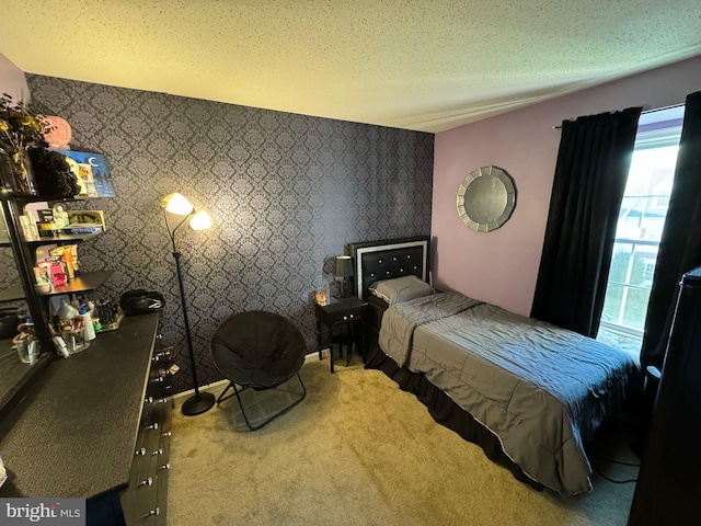 bedroom featuring a textured ceiling and carpet floors