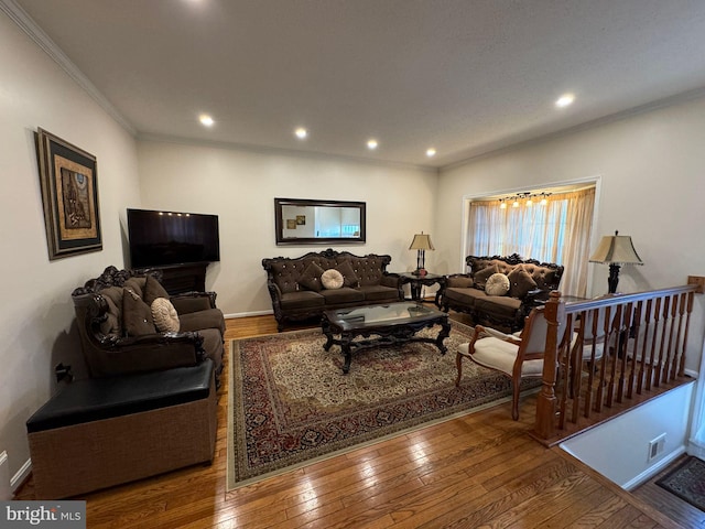 living room with hardwood / wood-style flooring and ornamental molding