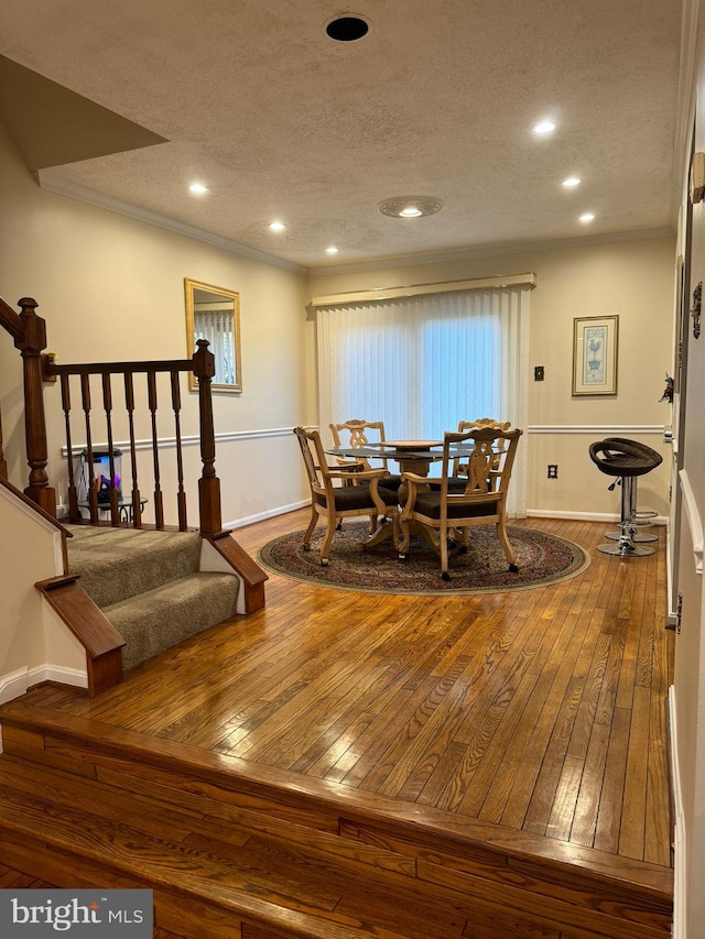 dining room with a textured ceiling and hardwood / wood-style flooring