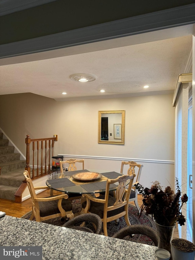 dining space with wood-type flooring