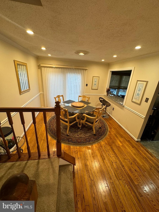 dining area featuring hardwood / wood-style flooring and a textured ceiling