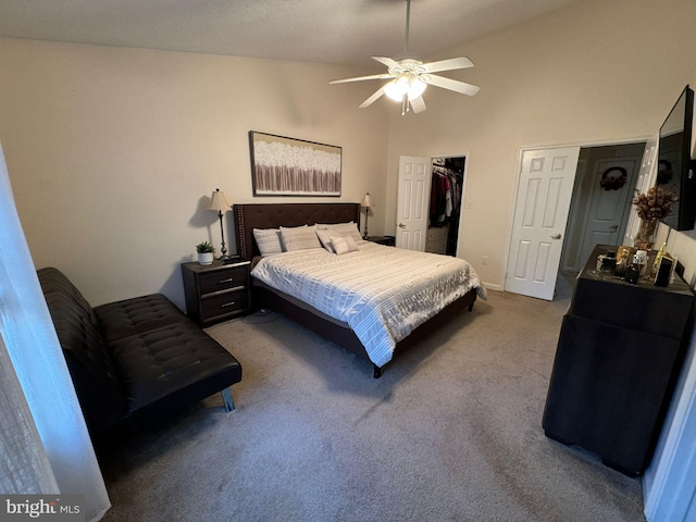 bedroom featuring high vaulted ceiling, a walk in closet, light colored carpet, and ceiling fan