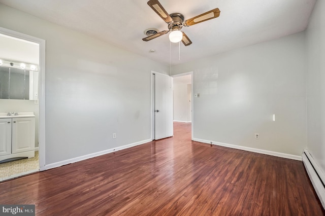 unfurnished bedroom featuring dark hardwood / wood-style flooring, ensuite bathroom, baseboard heating, and ceiling fan