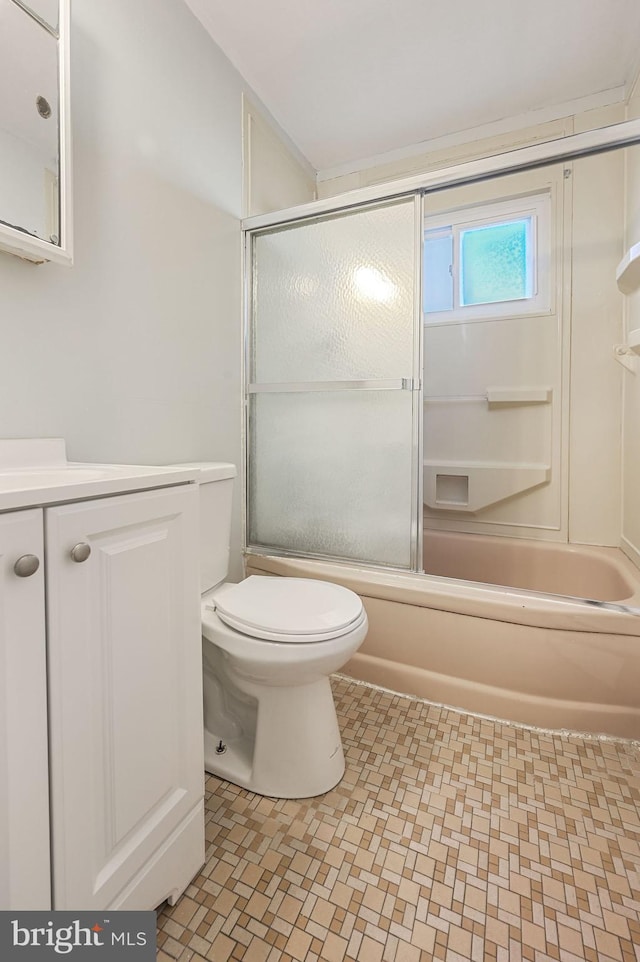 full bathroom featuring vanity, toilet, and combined bath / shower with glass door