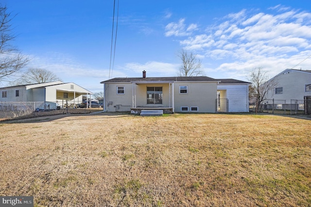 rear view of house with a yard