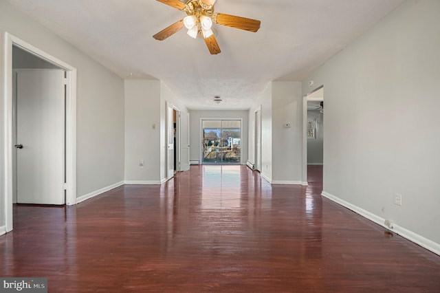 empty room featuring ceiling fan and dark hardwood / wood-style floors