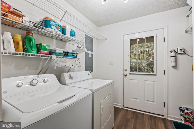 washroom featuring washer and dryer, a textured ceiling, and dark wood-type flooring