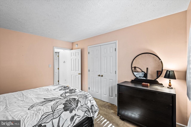 bedroom featuring a closet, a textured ceiling, and carpet