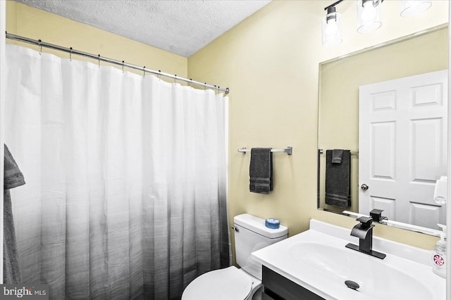 bathroom featuring toilet, a textured ceiling, vanity, and a shower with shower curtain