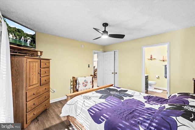 bedroom featuring ceiling fan, hardwood / wood-style flooring, a textured ceiling, and ensuite bath