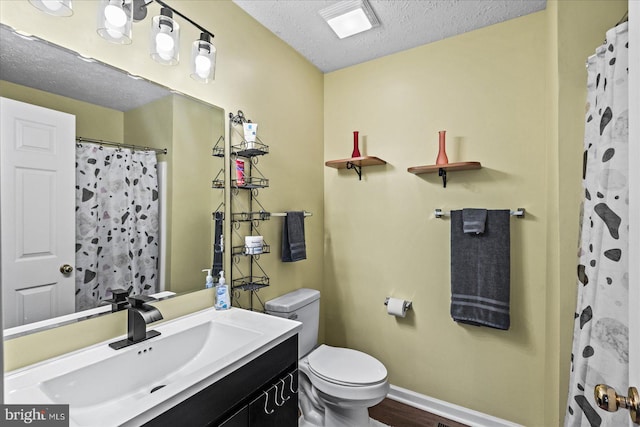 bathroom featuring hardwood / wood-style flooring, toilet, a shower with shower curtain, vanity, and a textured ceiling