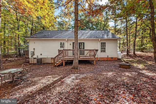 back of house featuring central AC and a wooden deck