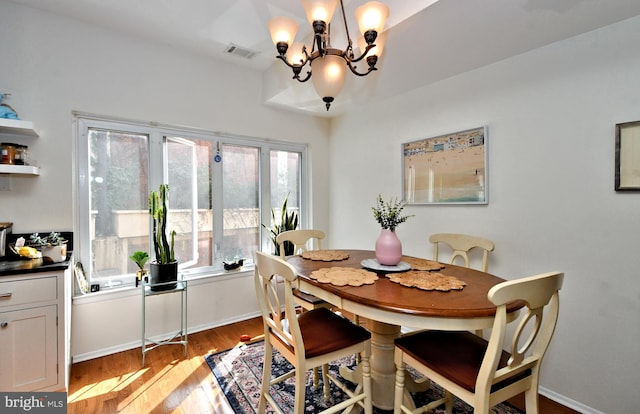 dining space with a chandelier and light hardwood / wood-style floors