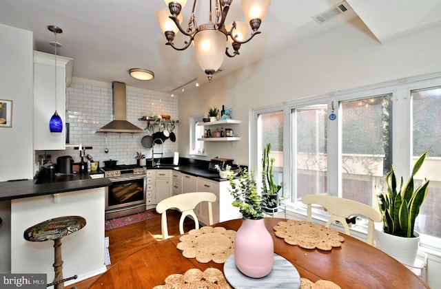 dining room with an inviting chandelier, dark hardwood / wood-style flooring, and sink