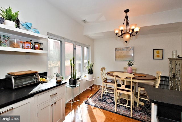 dining room featuring wood-type flooring and a chandelier