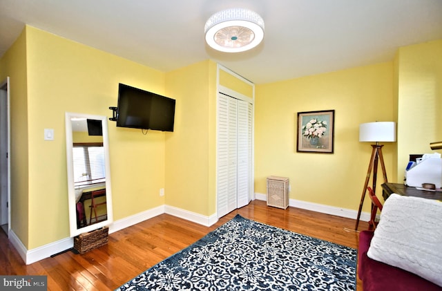 bedroom with a closet and hardwood / wood-style floors