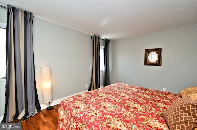 bedroom with wood-type flooring