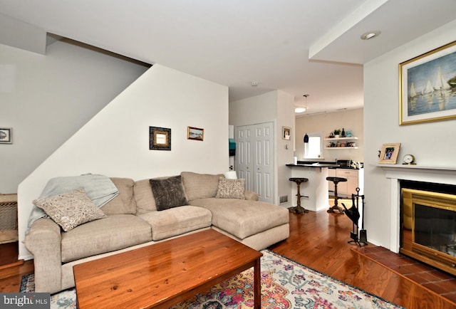 living room with a fireplace and hardwood / wood-style floors