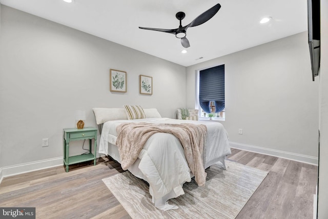 bedroom featuring ceiling fan and light hardwood / wood-style flooring