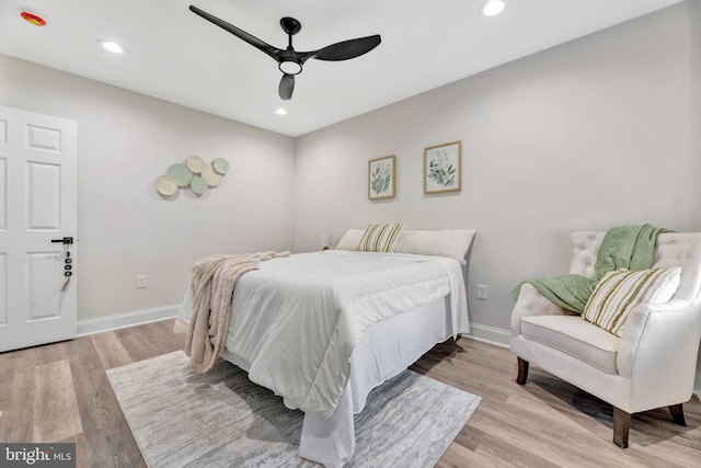 bedroom with ceiling fan and light hardwood / wood-style floors