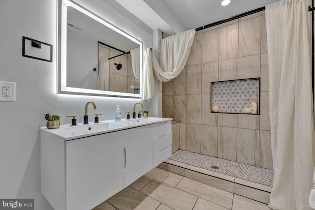 bathroom with tile patterned floors, walk in shower, and vanity